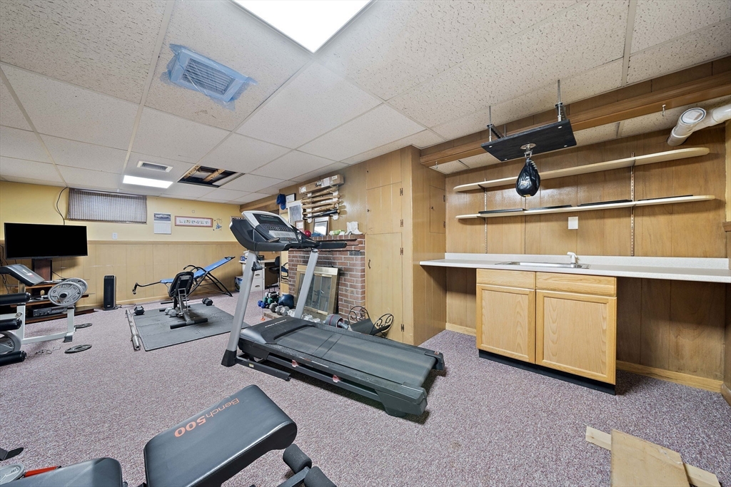 16 Jay Road Weymouth, MA 02190 - Photo 30 of 40 a room with gym equipment and a flat screen tv