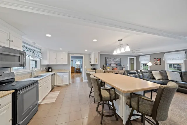 a large kitchen with a table and chairs