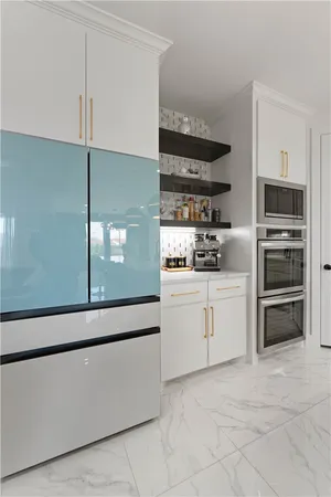 a kitchen with cabinets and stainless steel appliances