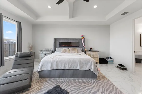 a bedroom with a bed and a large window