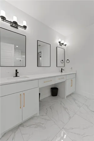 a bathroom with a sink vanity and mirror