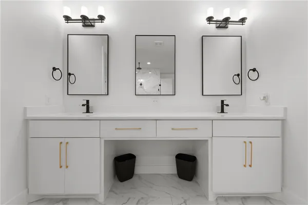 a bathroom with double vanity sink and a mirror
