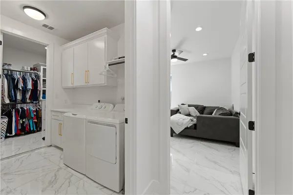 a hallway with cabinets and a couch