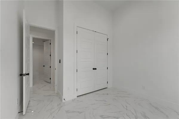 a bedroom that has a bed and a dresser in it