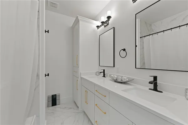 a bathroom with a double vanity sink and a mirror