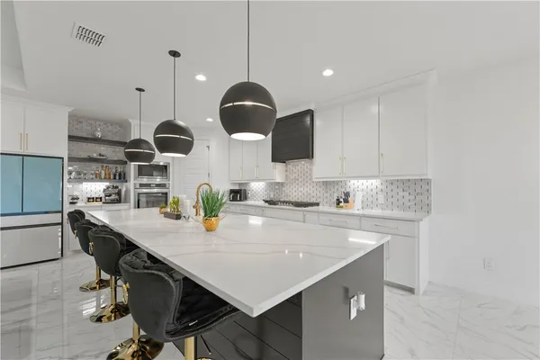 a kitchen with kitchen island appliances and a center island