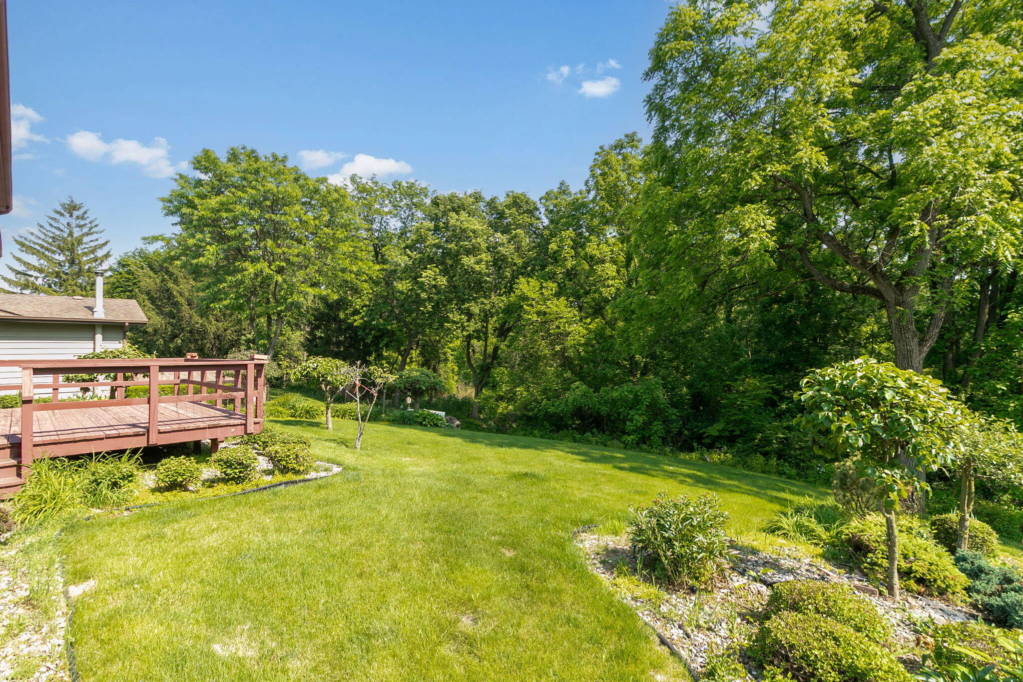 1121 Cheyenne Drive Crown Point, IN 46307 - Photo 17 of 18 a view of a swimming pool with a bench and trees in the background