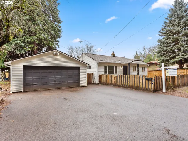 a view of a house with a yard and garage
