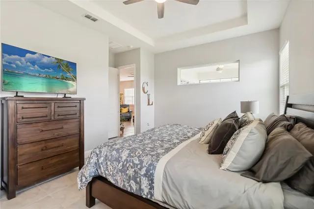 a bedroom with a bed and a flat tv screen