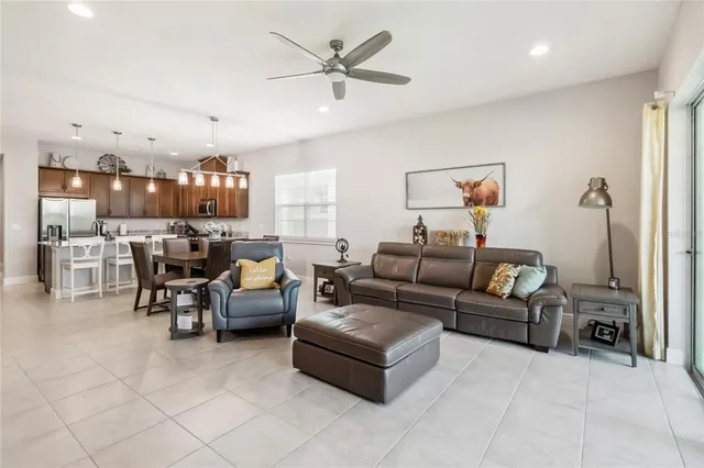 a living room with furniture and kitchen view