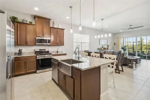 a kitchen with counter space appliances and a living room view
