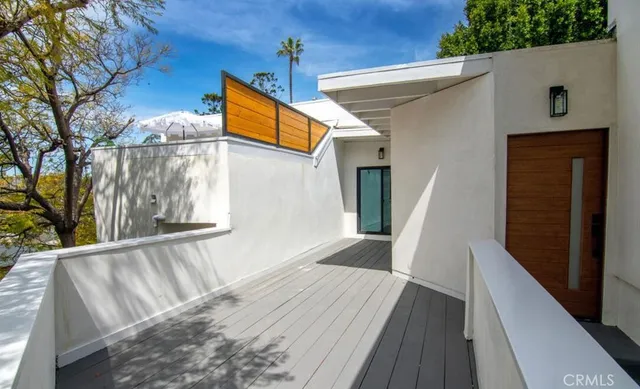a view of balcony with wooden floor and fence