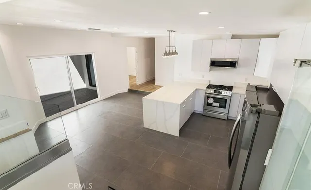 a view of kitchen with sink microwave and refrigerator