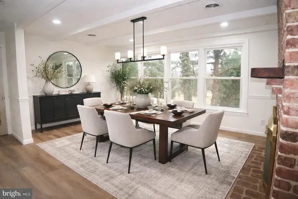 a view of empty room with wooden floor and fireplace