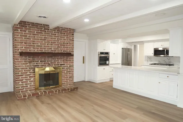 a kitchen with stainless steel appliances granite countertop a sink a stove a microwave and cabinets