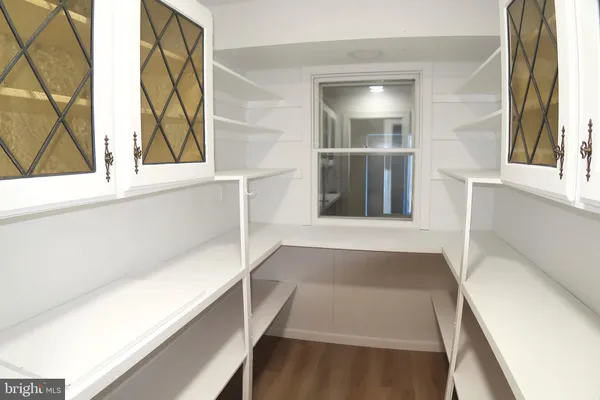 a kitchen with cabinets stainless steel appliances a sink and a window