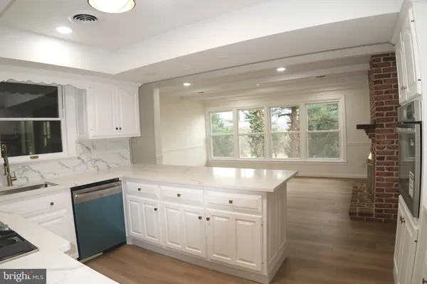 a view of a room with wooden floor and a window