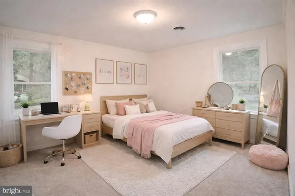 a bedroom with a bed and painting on the wall