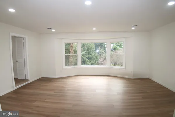a living room with furniture a flat screen tv and a rug