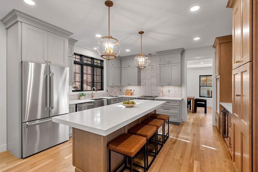 59 Dexter Road Melrose, MA 02176 - Photo 12 of 41 a kitchen with a refrigerator a sink and chairs