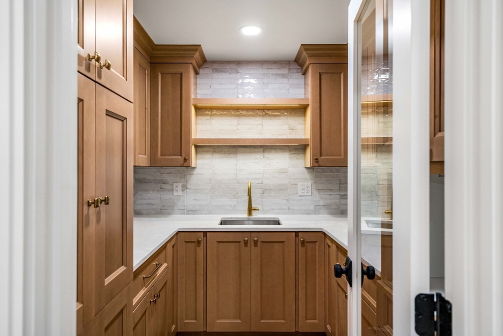 59 Dexter Road Melrose, MA 02176 - Photo 17 of 41 a bathroom with a sink a mirror and shower