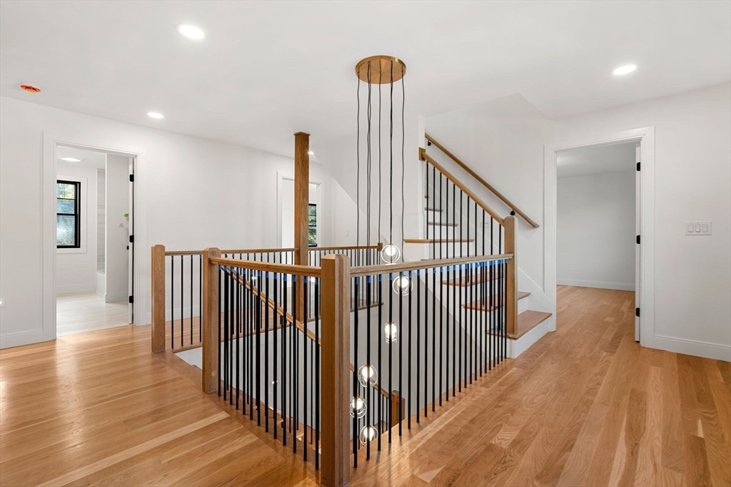 59 Dexter Road Melrose, MA 02176 - Photo 24 of 41 a view of a hallway with wooden floor and windows