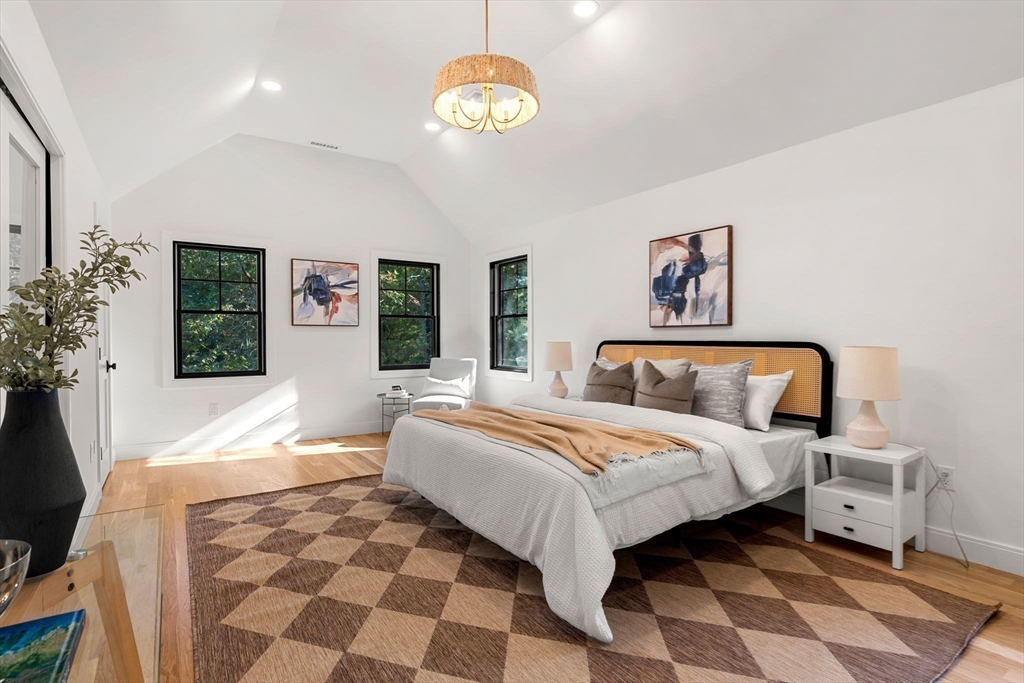 59 Dexter Road Melrose, MA 02176 - Photo 28 of 41 a bedroom with a bed and a chandelier