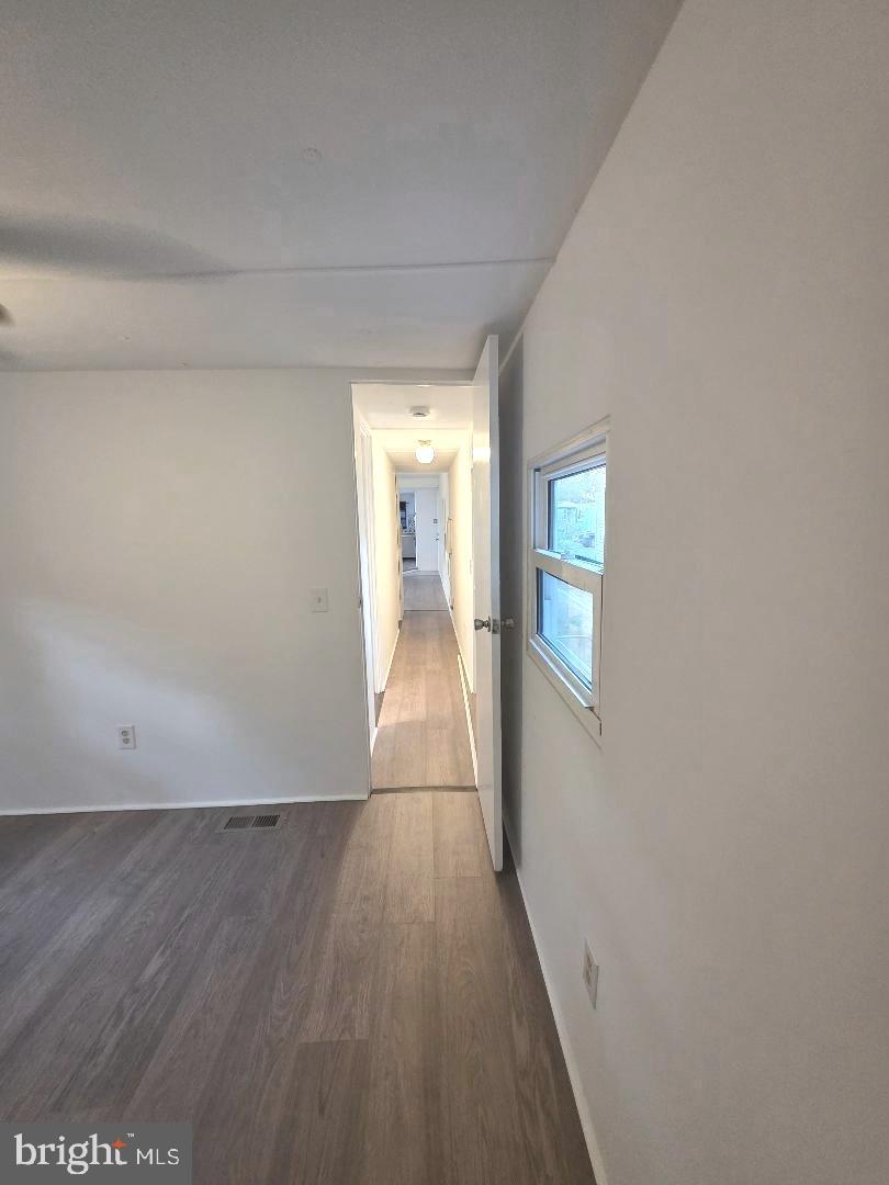 1762 Crown Point Road, Unit 2310B West Deptford, NJ 08086 - Photo 21 of 39 a view of a hallway with wooden floor and staircase
