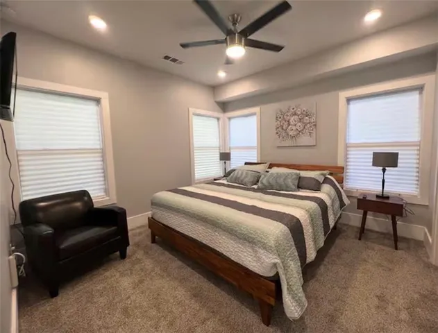 a bedroom with a bed and a couch