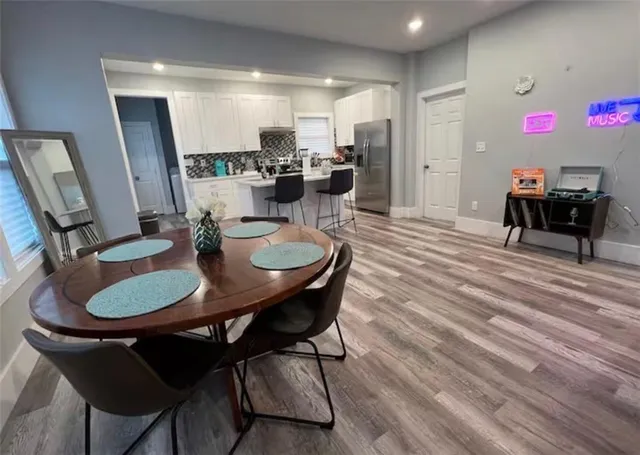a dining room with furniture and wooden floor