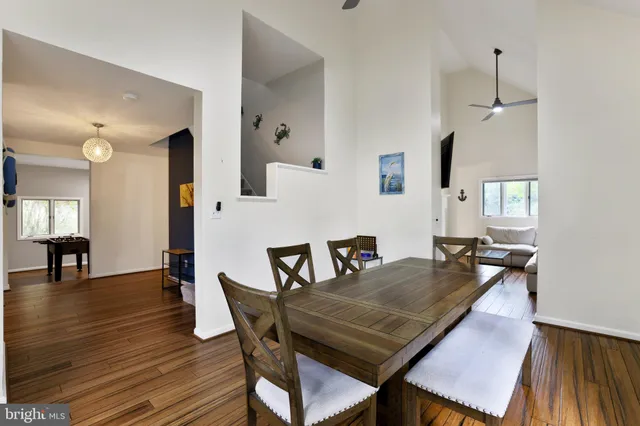a view of a workspace with furniture and a wooden floor