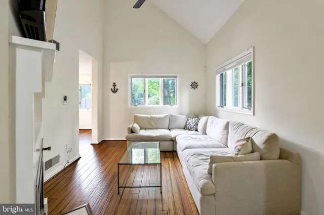 a view of a workspace with furniture and wooden floor