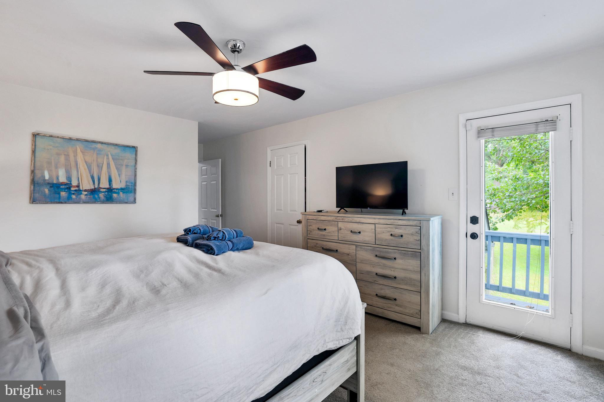 920 Old Annapolis Neck Road Annapolis, MD 21403 - Photo 25 of 58 a bedroom with a bed and a flat screen tv