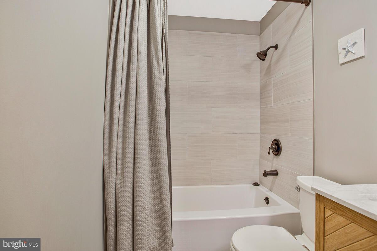 920 Old Annapolis Neck Road Annapolis, MD 21403 - Photo 30 of 58 a bathroom with a bathtub and a shower