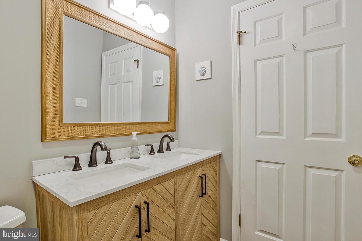 920 Old Annapolis Neck Road Annapolis, MD 21403 - Photo 31 of 58 a bathroom with a sink vanity and a mirror