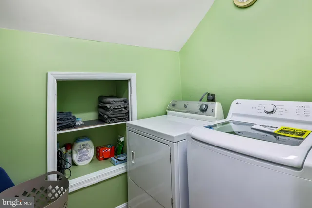 a bedroom with furniture and a flat screen tv