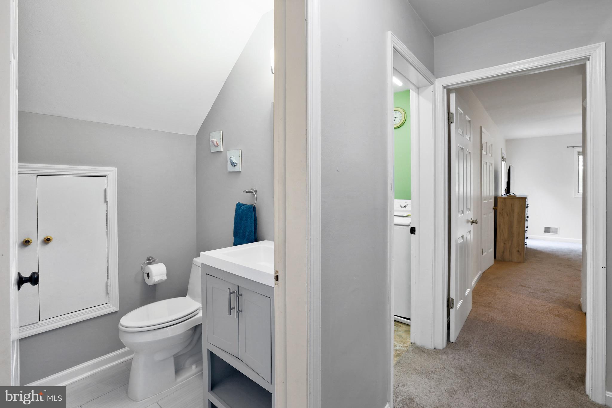 920 Old Annapolis Neck Road Annapolis, MD 21403 - Photo 35 of 58 a bathroom with a granite countertop toilet a sink and a mirror