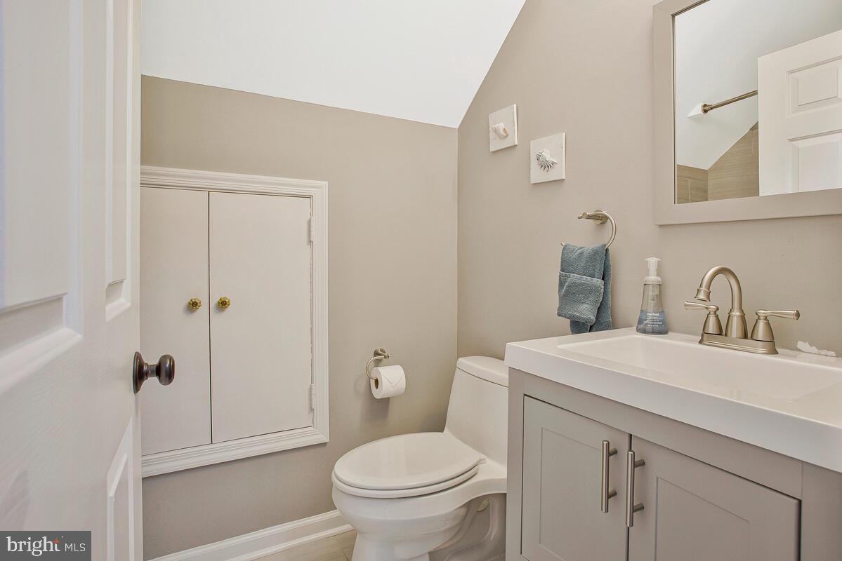 920 Old Annapolis Neck Road Annapolis, MD 21403 - Photo 36 of 58 a bathroom with a sink a toilet and shower