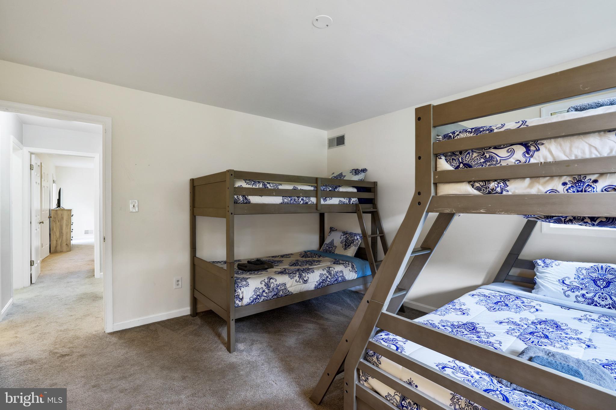 920 Old Annapolis Neck Road Annapolis, MD 21403 - Photo 38 of 58 a bedroom with furniture and a book shelf