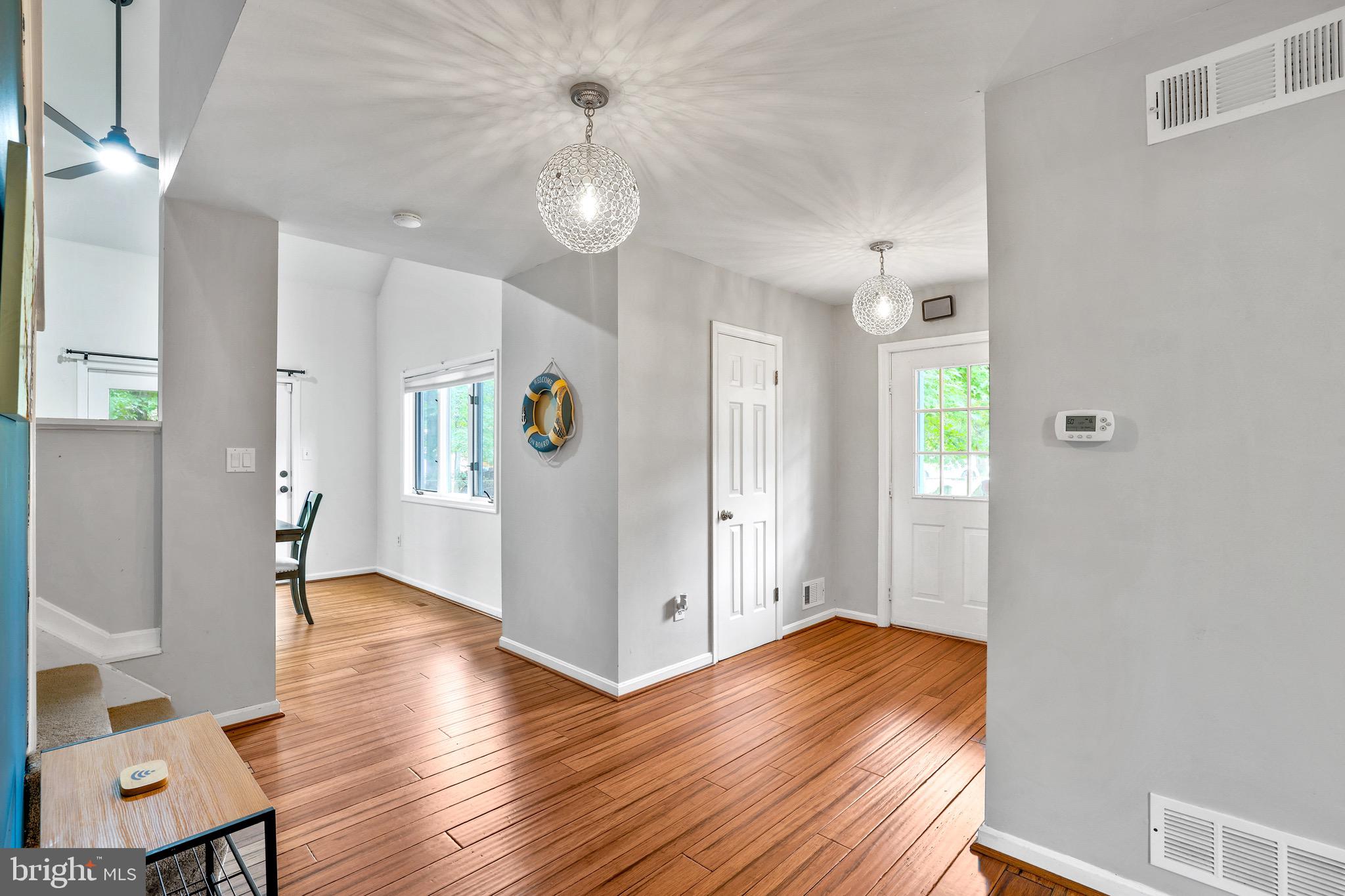 920 Old Annapolis Neck Road Annapolis, MD 21403 - Photo 7 of 58 a view of a hallway with wooden floor and a living room