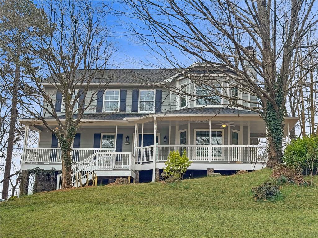 1028 Boston Ridge Woodstock, GA 30189 - Photo 1 of 37 a front view of a house with a yard table and chairs