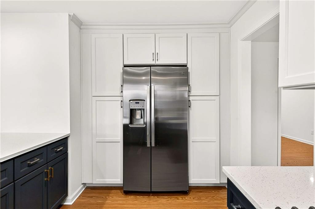 1028 Boston Ridge Woodstock, GA 30189 - Photo 12 of 37 a view of a kitchen with refrigerator and wooden floor