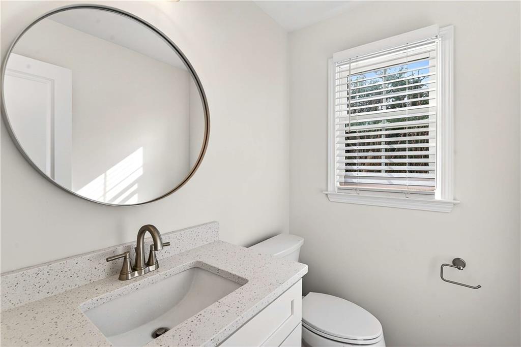 1028 Boston Ridge Woodstock, GA 30189 - Photo 17 of 37 a bathroom with a toilet a sink and a mirror