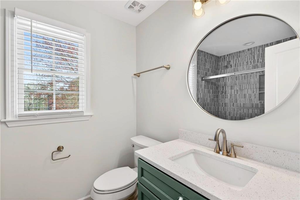 1028 Boston Ridge Woodstock, GA 30189 - Photo 25 of 37 a bathroom with a sink a toilet and a mirror