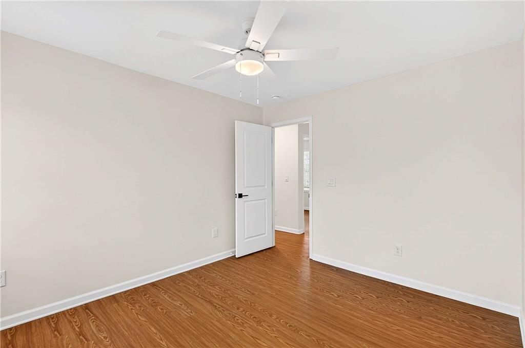 1028 Boston Ridge Woodstock, GA 30189 - Photo 29 of 37 an empty room with wooden floor and fan