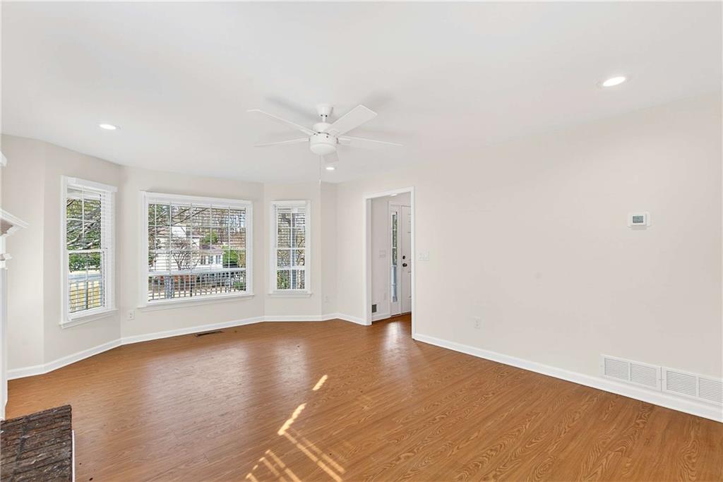1028 Boston Ridge Woodstock, GA 30189 - Photo 6 of 37 a view of an empty room with a window and wooden floor
