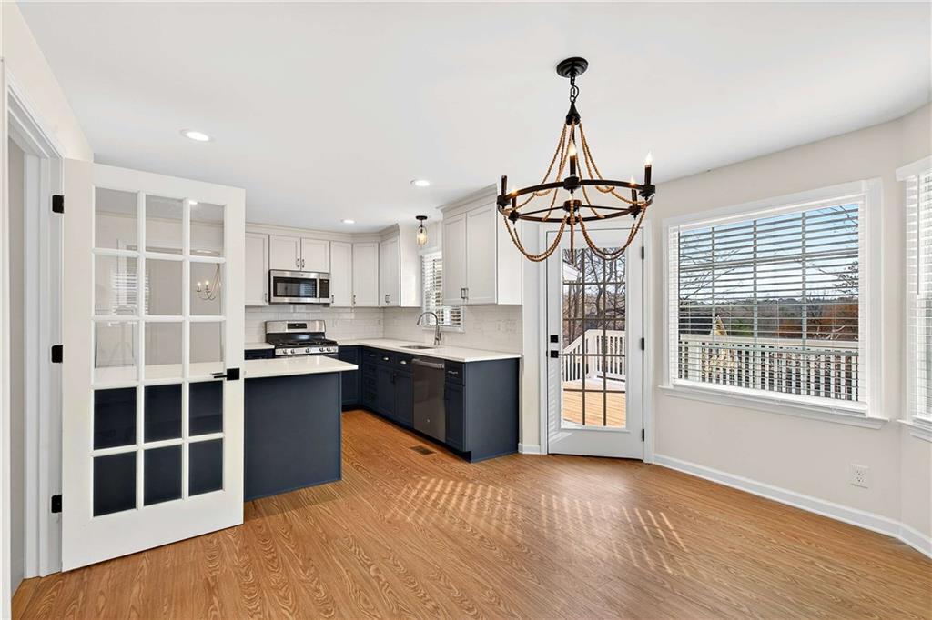 1028 Boston Ridge Woodstock, GA 30189 - Photo 7 of 37 a kitchen with stainless steel appliances granite countertop a stove a sink and a refrigerator