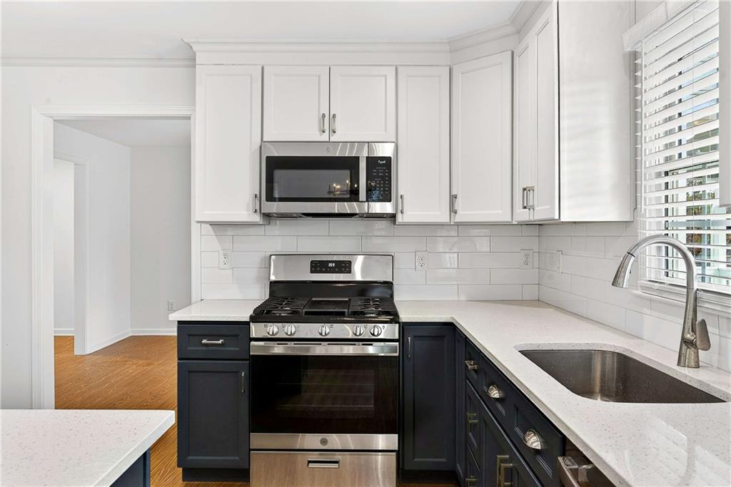 1028 Boston Ridge Woodstock, GA 30189 - Photo 10 of 37 a kitchen with cabinets stainless steel appliances a sink and a stove