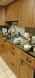 a kitchen with a stove a sink and cabinets