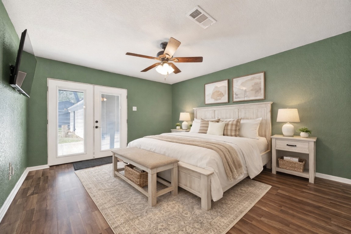 1619 Ashway Street Conroe, TX 77385 - Photo 11 of 40 Virtually staged view of the primary bedroom, the French doors open to the deck with pergola that overlooks the pool.